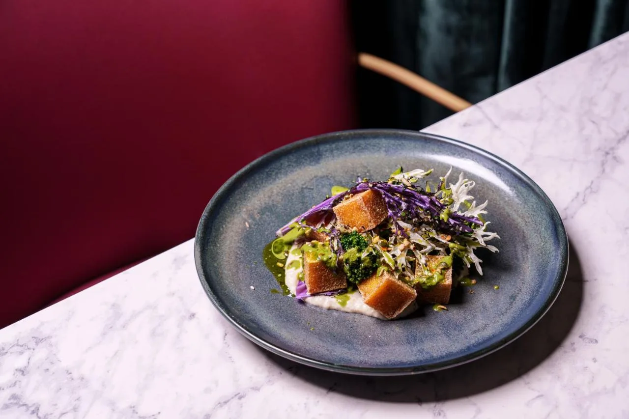 a plate of food with a salad on a table at Apex Waterloo Place Hotel in Edinburgh